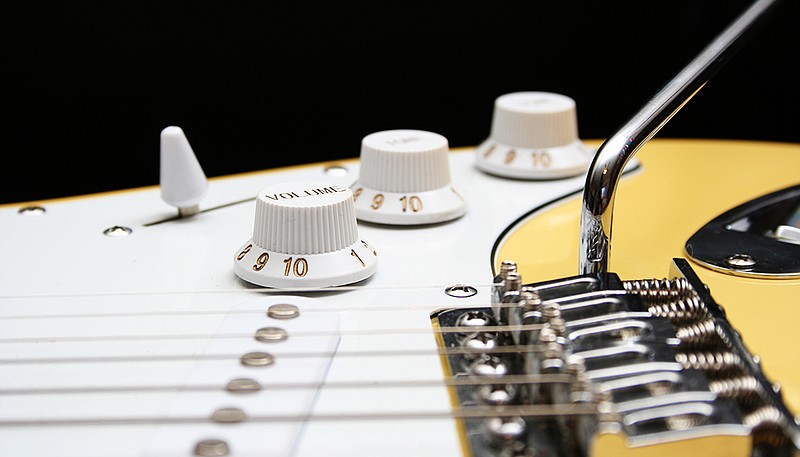 An eye level view of the surface of an electric guitar.