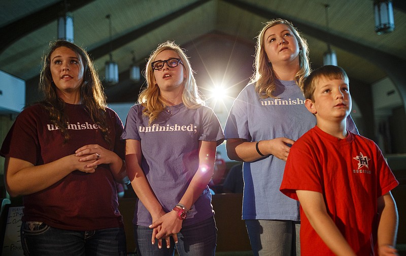Bryce McDaniel, Isabelle Hill, Madison Hughes and Greyson Gerrells, from left, watch performers at a teen suicide prevention program titled "Unfinished" at New Salem Baptist Church in Soddy-Daisy.