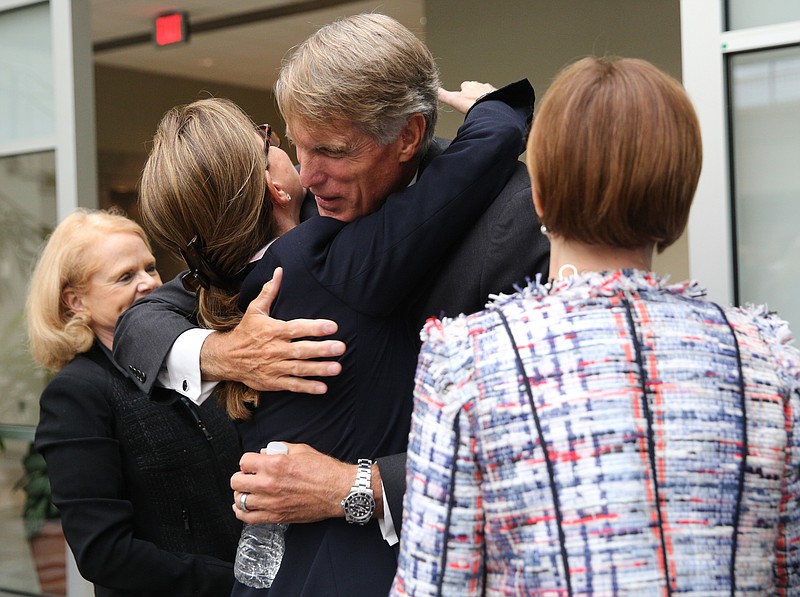 Pamela Godwin, Cynthia Egan and Gloria Larson, all on Unum's board of directors, hug Tom Watjen after the Unum Group Annual Shareholder Meeting at the Unum headquarters building in Chattanooga, Tenn., on Thursday, May 25, 2017. The longtime former Unum CEO and board member Tom Watjen retired during the meeting. 