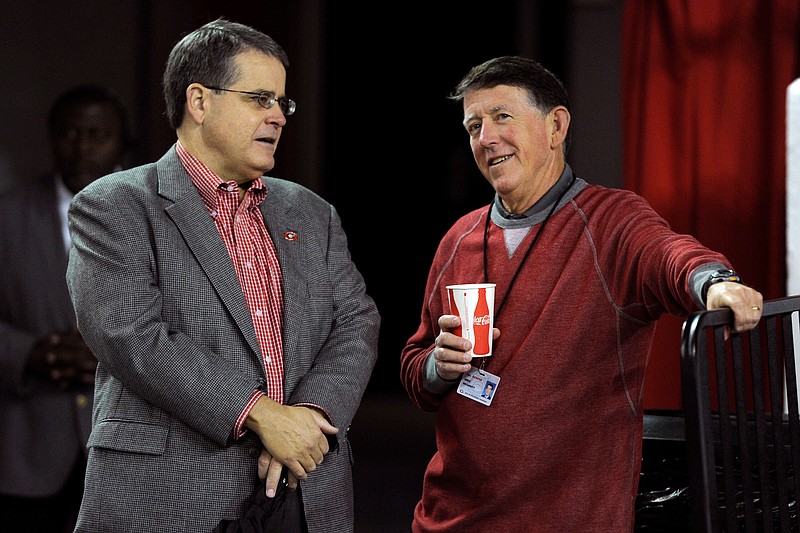 University of Georgia president Jere Morehead, left, remains confident in an athletic program headed by Greg McGarity, right, despite a difficult 2016-17 year.