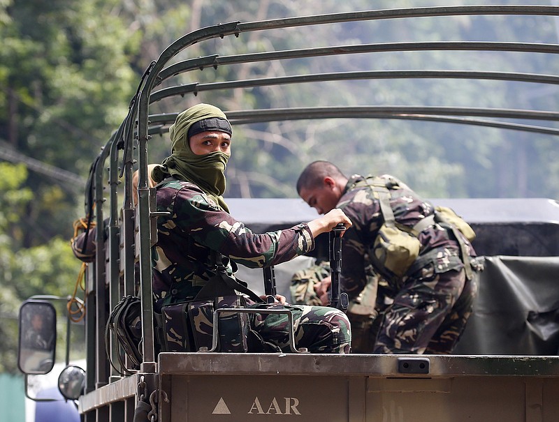 
              Government troops head for a continuing military operation against Muslim militants who lay siege in Marawi city Friday, May 26, 2017 at Bal-oi township, Lanao del Norte province in southern Philippines. Philippine army generals say dozens of Islamic State group-linked extremists have been killed in two days of fighting in a southern city that has been under siege since one of Asia's most-wanted militants evaded capture and dozens of rebels came to his aid. (AP Photo/Bullit Marquez)
            