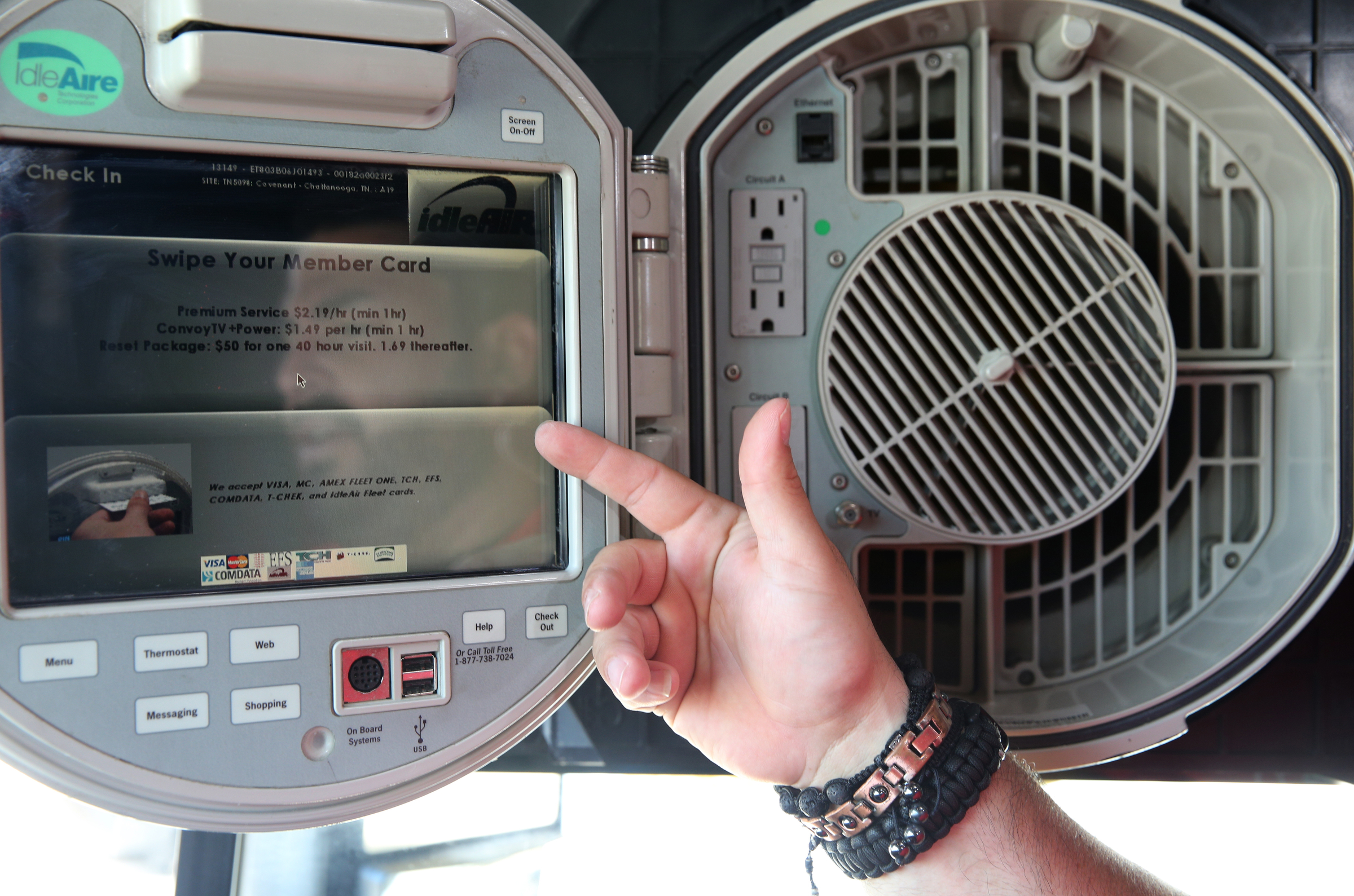 Esteban Torres, master trainer at Covenant Transport, shows off features of the IdleAir system Friday, May 26, 2017, at Covenant Transport in Chattanooga, Tenn. Covenant's IdleAir system allows truck drivers to hook their cabs up to electricity, so they can rest or sleep without having to run their diesel engines, reducing pollution.