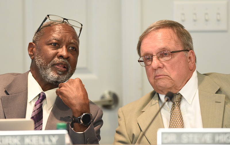 School board Chairman Dr.Steve Highlander, right, speaking to interim Superintendent Dr. Kirk Kelly at a board meeting last fall, appears to want a quick finish to the board's superintendent search.