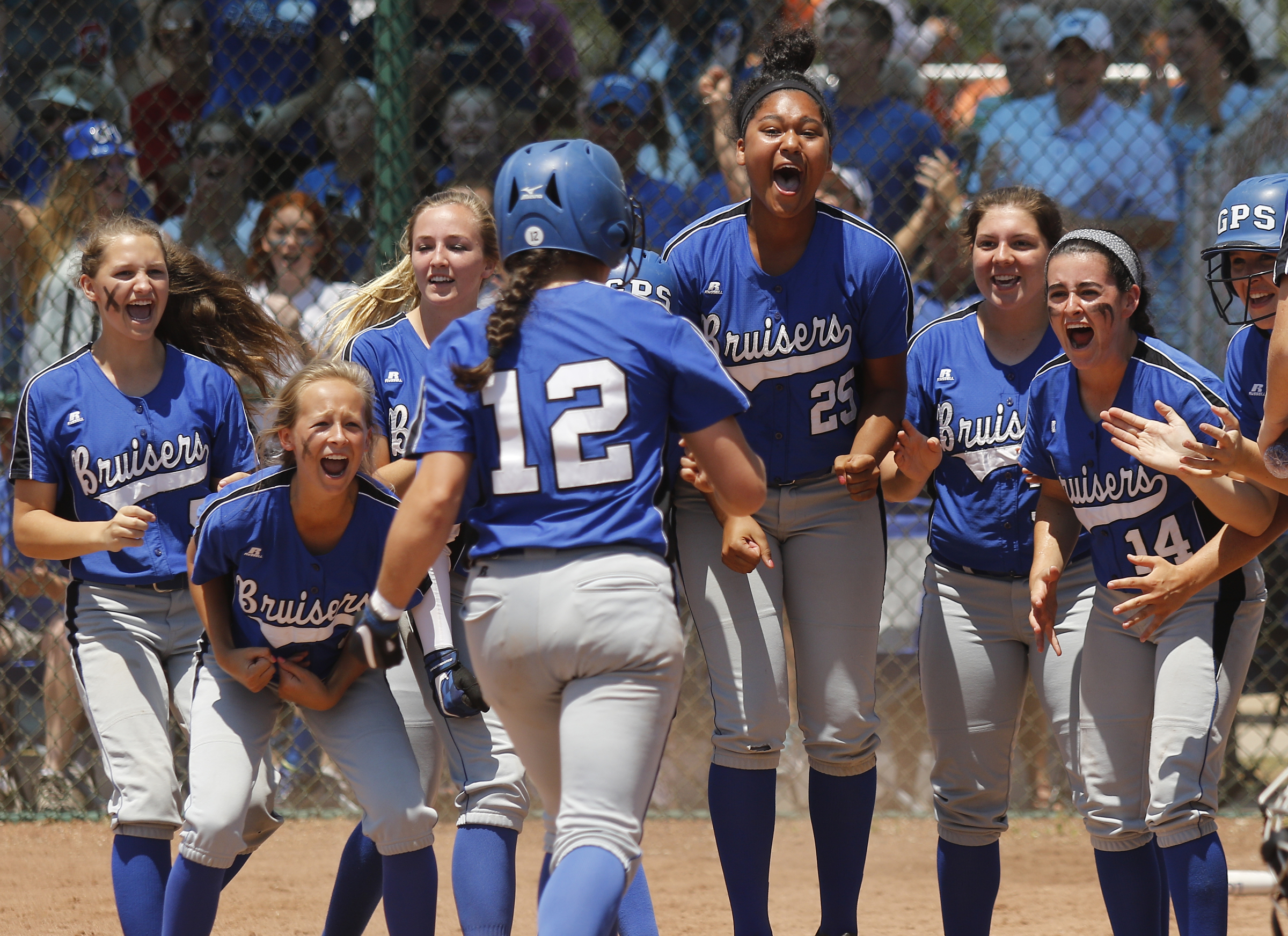 GPS players welcome runner Haley Smith home after she was brought in by teammate Hannah Kincer's homer during their TSSAA Division II-AA state softball championship game 1 against Baylor on Friday, May 26, 2017, in Murfreesboro, Tenn.