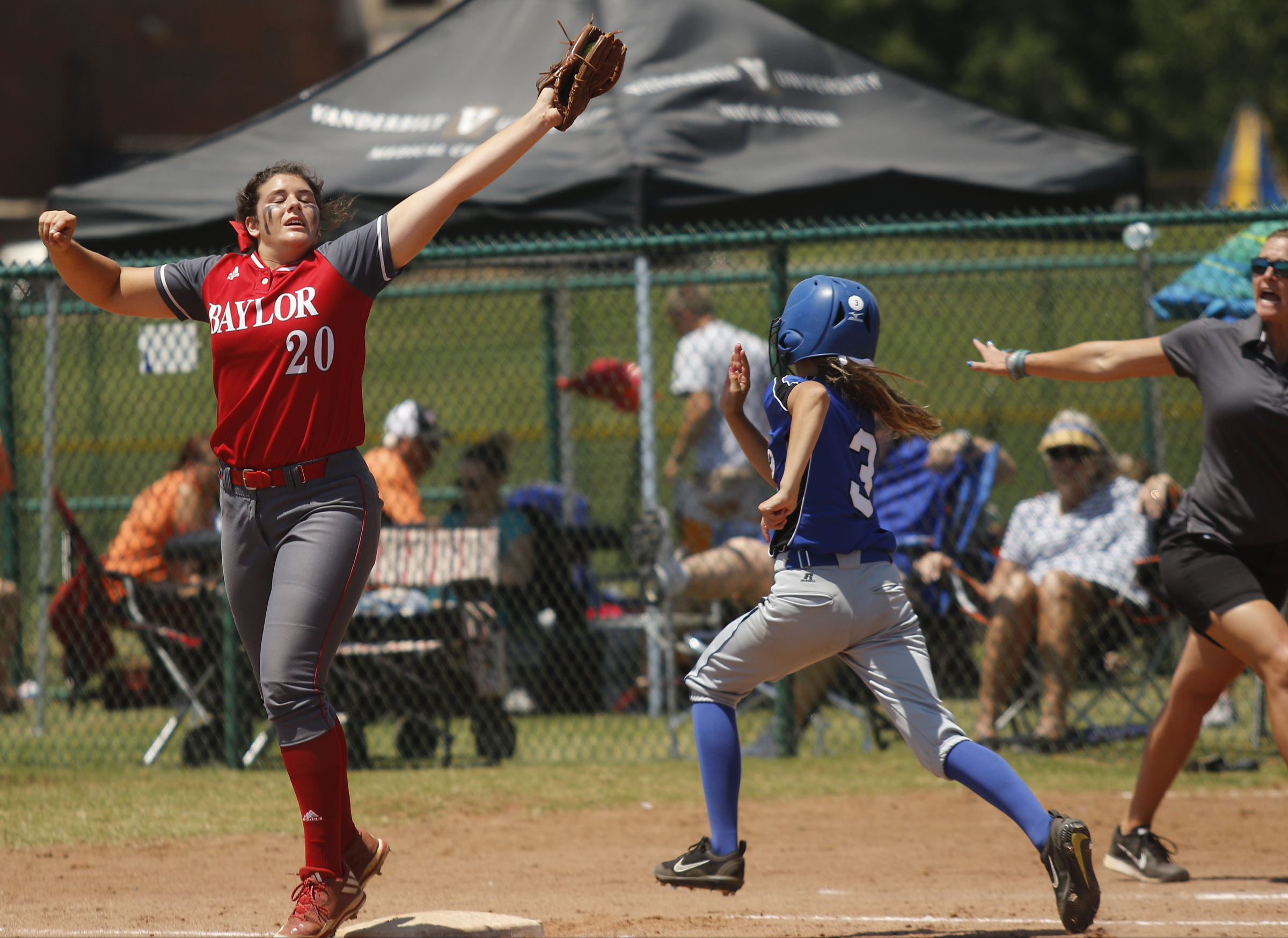 GPS runner Chapel Cunningham heads for first as a throw to Baylor 1st baseman Macy McKnight goes high during their TSSAA Division II-AA state softball championship game 1 on Friday, May 26, 2017, in Murfreesboro, Tenn.