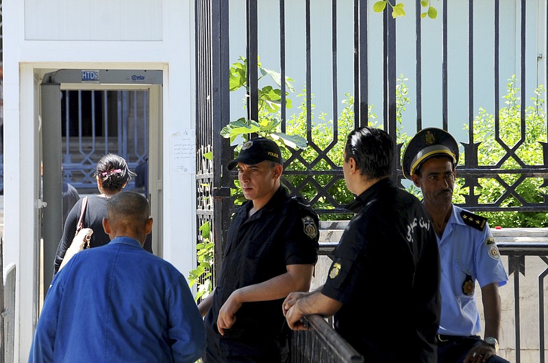 
              Tunisian security forces guard the Tunis hall of justice, Friday May, 26, 2017. A court held on its first public hearing in the trial of 26 people in connection with an attack on a beach resort in Sousse that killed dozens of foreign tourists in 2015. (AP Photo/Hassene Dridi)
            