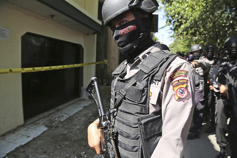 
              Police officers stand guard outside a house after a raid in Bandung, West Java, Indonesia, Friday, May 26, 2017. Indonesian police arrested three suspected militants Friday for their alleged involvement in twin suicide bombings that killed three people in Jakarta, while the Islamic State group claimed it was responsible for the attack. (AP Photo)
            