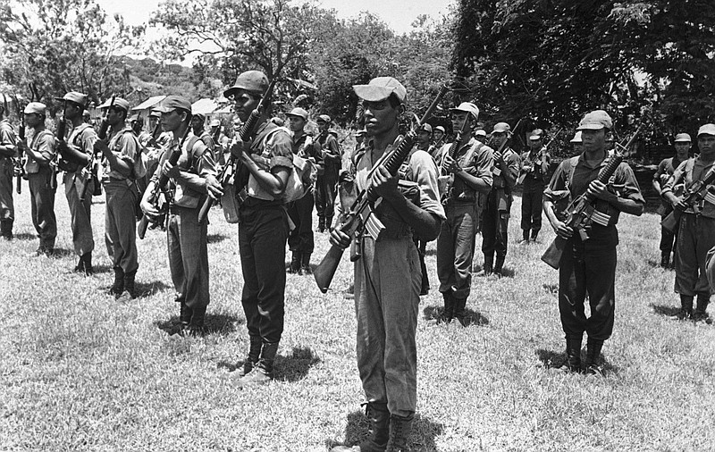
              FILE - In this 1986 file photo, Sri Lankan government troops perform a drill practice at a camp in Trincomalee, Sir Lanka. In 1983, civil war broke out, with rebels of the Liberation Tigers of Tamil Elam (or LTTE, known as Tamil Tigers) fighting government forces for an independent homeland for ethnic Tamils in northern and eastern regions of the island nation. (AP Photo/Liu Heung Shing)
            