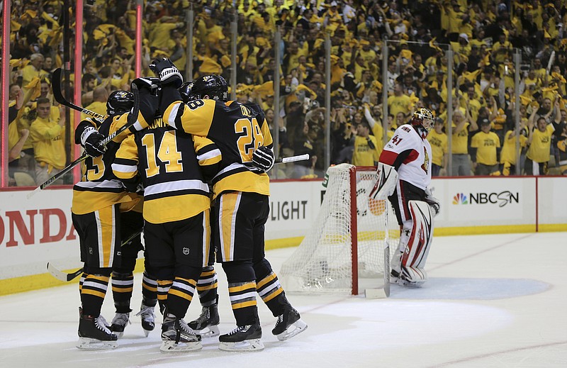 Pittsburgh Penguins left wing Chris Kunitz (14) celebrates with teammates after scoring a goal against the Ottawa Senators during the second period of Game 7 in the NHL hockey Stanley Cup Eastern Conference finals, Thursday, May 25, 2017, in Pittsburgh. (AP Photo/Keith Srakocic)