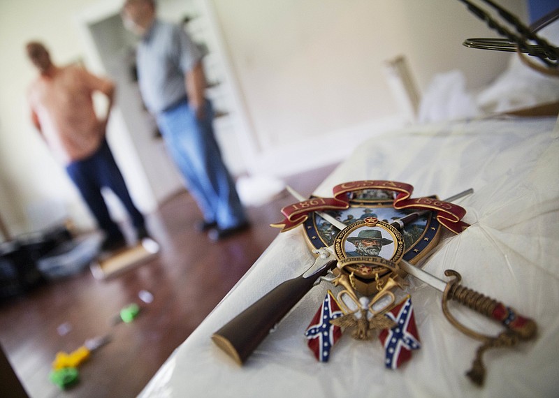 
              A piece of Confederate memorabilia to General Robert E. Lee sits atop a box at the Nash Farm Battlefield Museum, a small Civil War museum closing in Hampton, Ga., Thursday, May 25, 2017. Against the backdrop of the removal of Confederate symbols from public spaces around the South, the closure of the small Civil War museum in Georgia has stirred up strong emotions. (AP Photo/David Goldman)
            