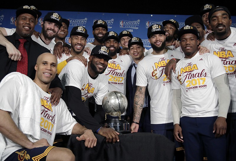 
              The Cleveland Cavaliers pose with their trophy after winning Game 5 of the NBA basketball Eastern Conference finals against the Boston Celtics 135-102, on Thursday, May 25, 2017, in Boston. (AP Photo/Elise Amendola)
            