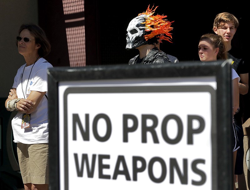 
              Fans line up to enter Comicon at the Phoenix Convention Center, Friday, May 26, 2017, in Phoenix. Comic book and science fiction fans showing up at the Phoenix Comicon festival will have all prop weapons - including swords, sabers and fake guns - confiscated after a man showed up at the event with real guns and caused a security scare.  (AP Photo/Matt York)
            