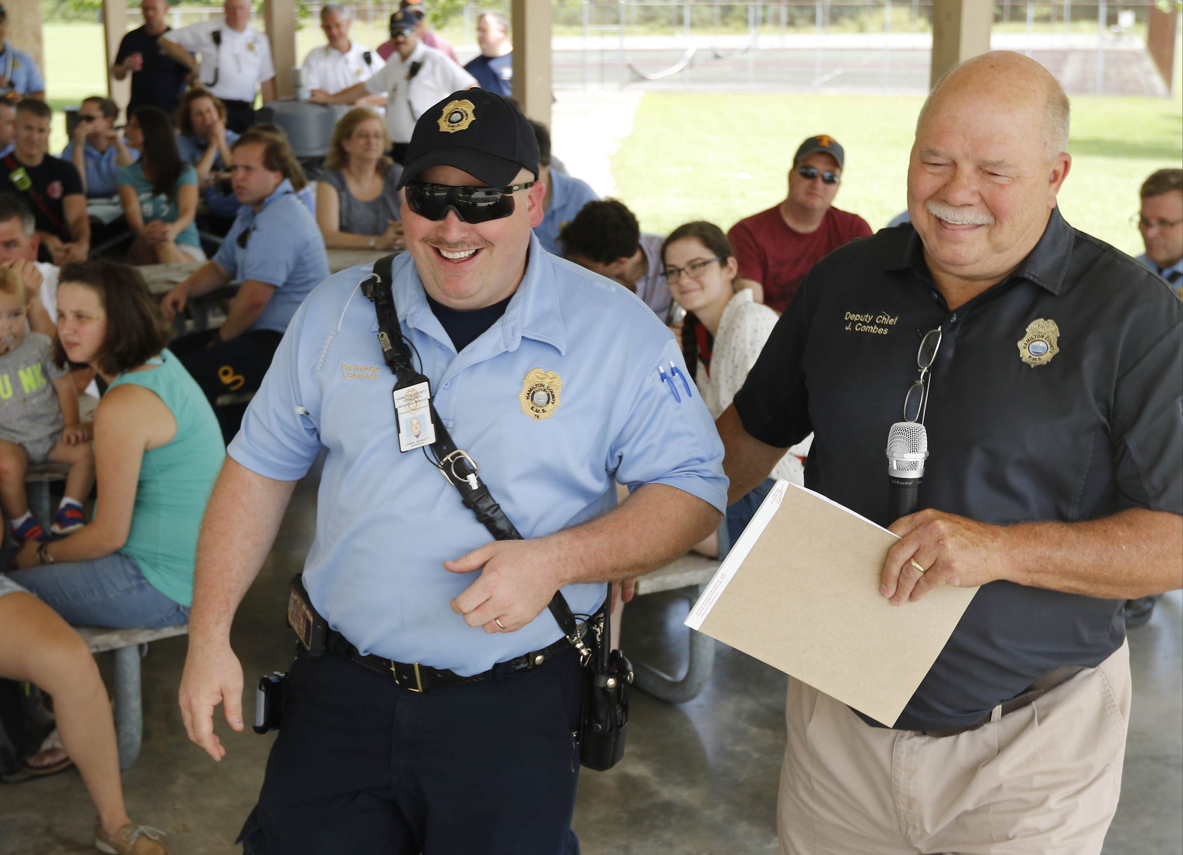 Deputy HCEMS chief John Combes, right, awards Lt. Bob Bennett with a blue ribbon award at the Hamilton County EMS awards ceremony at the Vulcan Materials Plant's picnic area on Saturday, May 27, 2017, in Chattanooga, Tenn.
