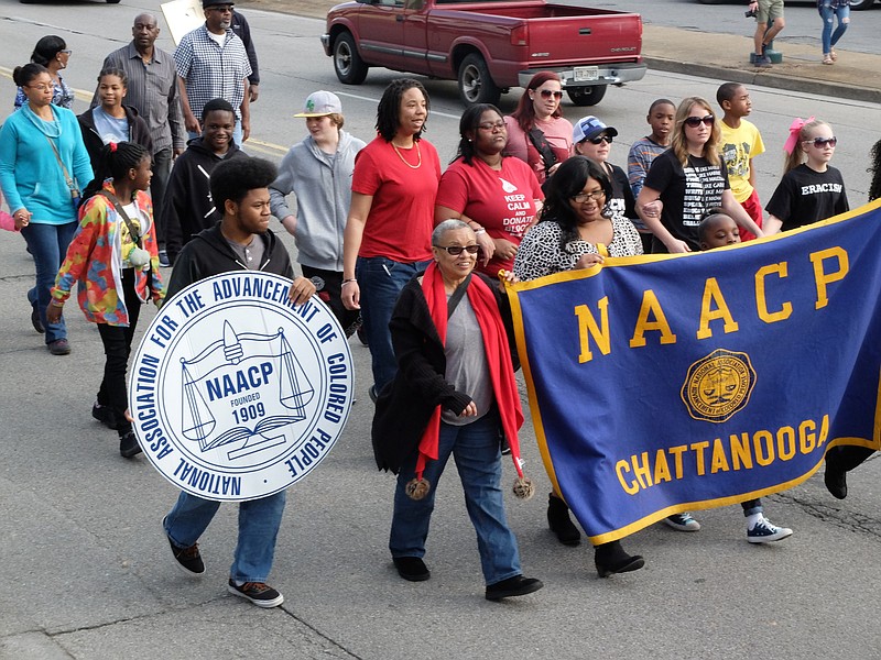 Staff photo by Tim Barber NAACP representatives march with hundreds of people on M.L. King Blvd. in the annual King March in downtown Chattanooga.