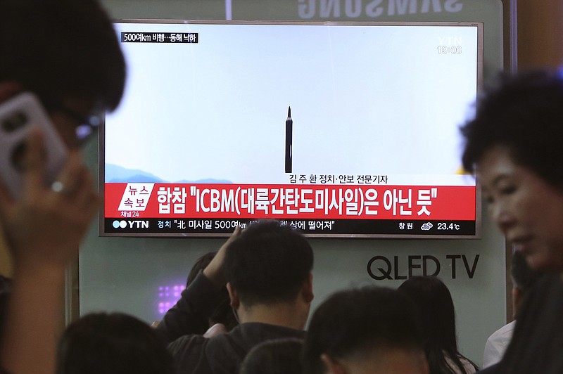 
              FILE - In this May 21, 2107 file photo people watch a TV news program showing a file image of a missile launch conducted by North Korea, at the Seoul Railway Station in Seoul, South Korea. With North Korea’s nuclear missile threat in mind, the Pentagon is planning a missile defense test next week that for the first time will target an intercontinental-range missile. (AP Photo/Ahn Young-joon, File)
            