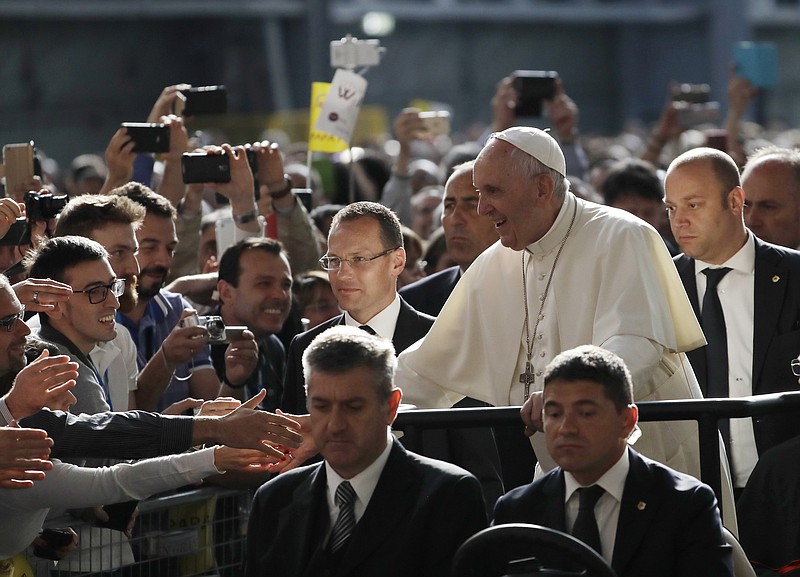 
              Pope Francis arrives at the ILVA steel-making company in Genoa, Italy, Saturday, May 27, 2017.  Pope Francis has begun a one-day visit to the northern Italian port city of Genoa to meet with workers, poor and homeless people, refugees and prisoners. His opened his visit at ILVA, a troubled steel-making company, where workers in hard hats awaited him. The visit puts a focus on the plight of workers whose lives have been made precarious by years of economic crisis. (AP Photo/Antonio Calanni)
            