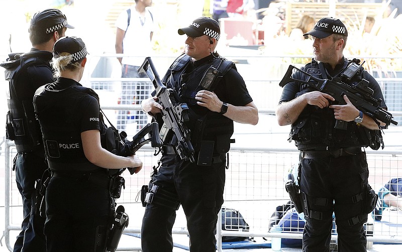 
              Armed police on guard prior to the start of the Great CityGames at Deansgate, in Manchester, England, Friday May 26, 2017. (Martin Rickett/PA via AP)
            