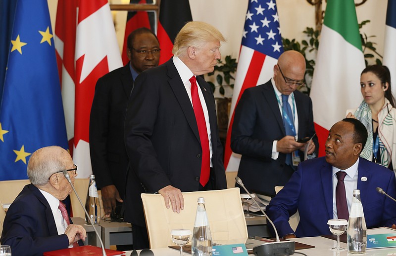 
              U.S. President Donald Trump, center, speaks with President of Niger Mahamadou Issoufou as they attend a round table meeting of G7 leaders and Outreach partners at the Hotel San Domenico during a G7 summit in Taormina, Italy, Saturday, May 27, 2017. Leaders of the G7 wrap up their meeting on Saturday with discussions focused on terrorism, climate and trade. (AP Photo/Domenico Stinellis)
            