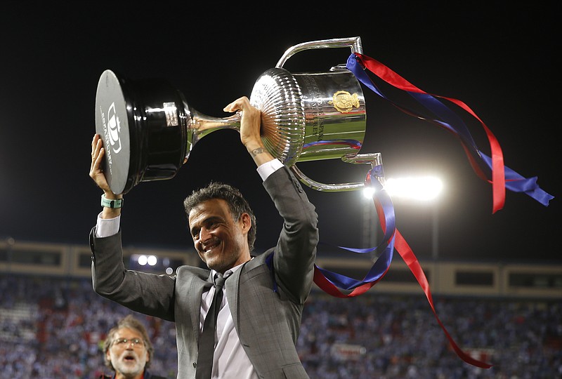 
              Barcelona's head coach Luis Enrique holds up the cup after winning the Copa del Rey final soccer match between Barcelona and Alaves at the Vicente Calderon stadium in Madrid, Spain, Saturday May 27, 2017. (AP Photo/Daniel Ochoa de Olza)
            