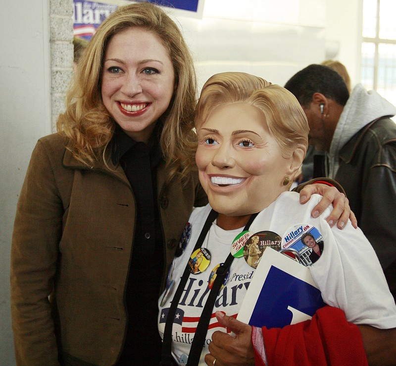 Chelsea Clinton, left, poses for a photograph with Helen V. Gonzales of San Antonio, Texas, who is wearing a Hillary Clinton mask, during the 2008 presidential campaign.