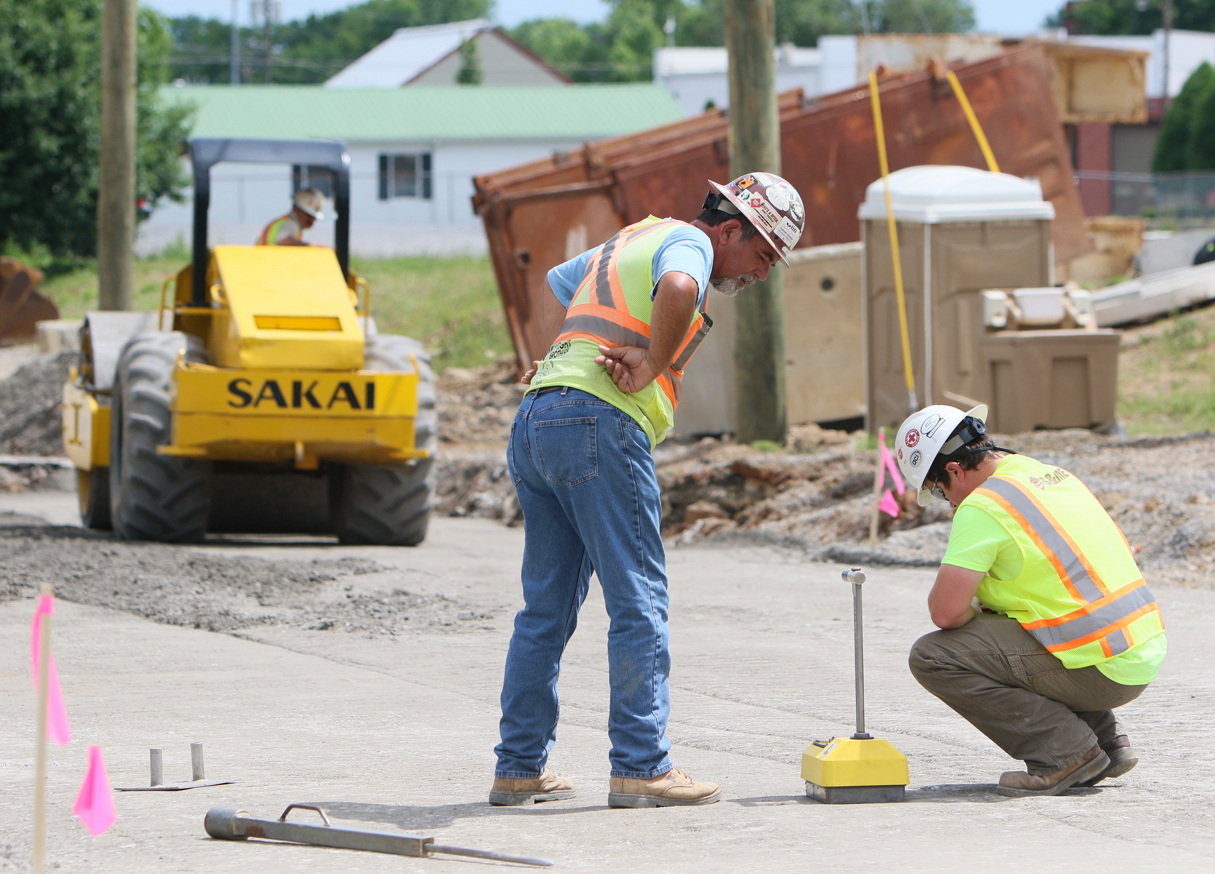 John Romines, site superintendent with Wright Brothers Construction Company, Inc., looks on as Scott Holloway, a construction materials technician with S&ME, Inc., performs a density test on the ground Friday, May 26, 2017, on St. Elmo Avenue at Broad Street in Chattanooga, Tenn. The drainage project will force closure of the intersection of Broad Street and St. Elmo Avenue for 90 days, starting in June.