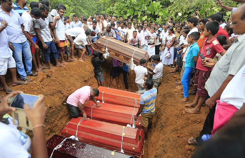 
              Sri Lankan villagers prepare to bury victims of a landslide at a cemetery in Bellana village, in Kalutara district in, Sri Lanka, Saturday, May 27, 2017. Sri Lanka has appealed for outside help as dozens were killed in floods and mudslides and dozens others went missing. (AP Photo/Eranga Jayawardena)
            