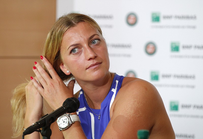 
              Petra Kvitova of the Czech Republic adjusts her hair during a press conference at the Roland Garros stadium, Friday, May 26, 2017 in Paris. Kvitova has confirmed she is making her comeback at the French Open, less than six months after being attacked by a knife-wielding intruder. Kvitova has missed all season so far while recovering from surgery on her left, racket-holding hand in December. (AP Photo/Christophe Ena)
            