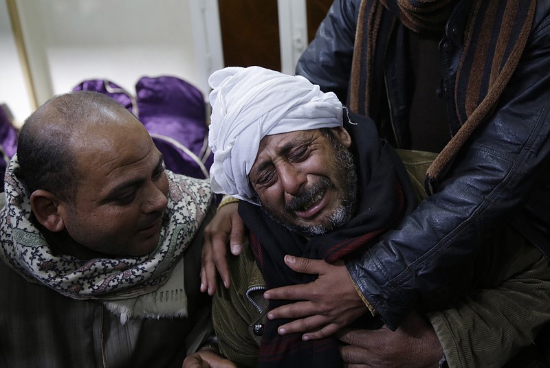 
              FILE - In this Monday, Feb. 16, 2015 file photo, a man is comforted by others as he mourns over Egyptian Coptic Christians who were captured in Libya and killed by militants affiliated with the Islamic State group, outside of the Virgin Mary church in the village of el-Aour, near Minya, 220 kilometers (135 miles) south of Cairo, Egypt. The Libya connection in the Manchester concert bombing and Friday’s attack on Christians in Egypt has shone a light on the threat posed by militant Islamic groups that have taken advantage of lawlessness in the troubled North African nation to put down roots, recruit fighters and export jihadists to cause death and carnage elsewhere.  (AP Photo/Hassan Ammar, File)
            