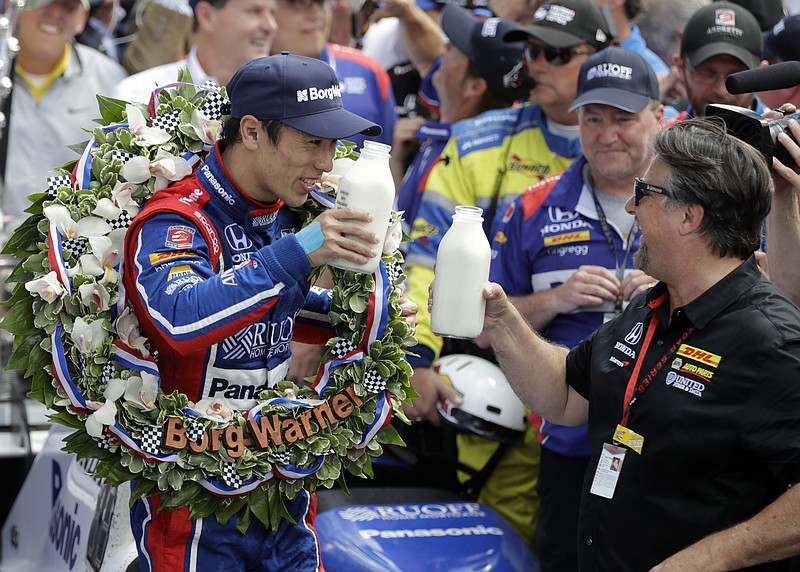 
              Takuma Sato, left, of Japan, toasts with car owner Michael Andretti as they celebrate after winning the Indianapolis 500 auto race at Indianapolis Motor Speedway, Sunday, May 28, 2017, in Indianapolis. (AP Photo/Darron Cummings)
            