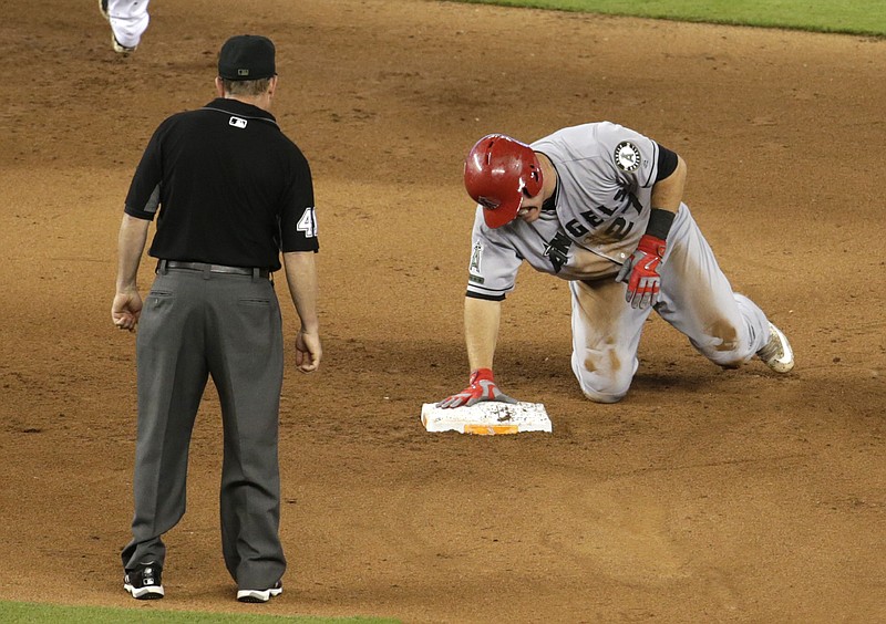 
              Los Angeles Angels' Mike Trout grimaces after stealing second during the fifth inning of an interleague baseball game against the Miami Marlins, Sunday, May 28, 2017, in Miami. Trout injured his thumb on the play. (AP Photo/Lynne Sladky)
            