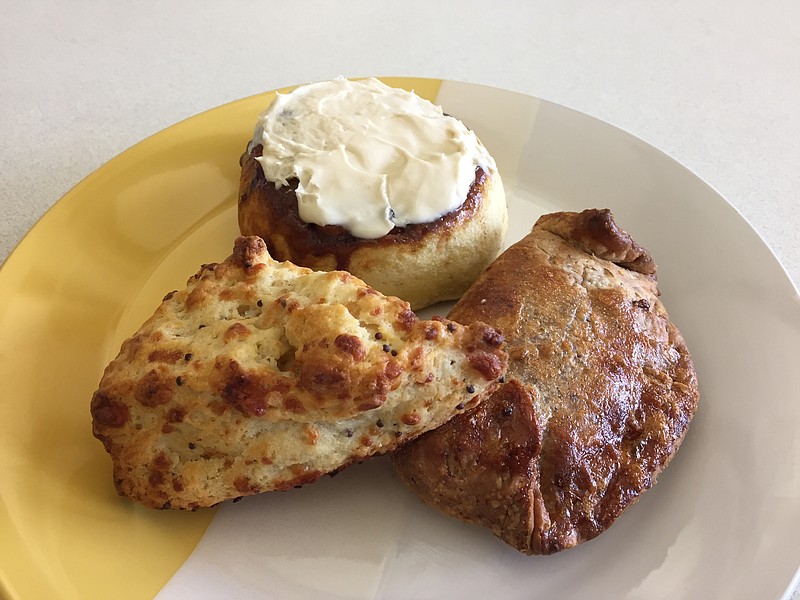 Bread & Butter Bakery offers a variety of pastries, such as the Mustard & Gruyere Scone, cinnamon roll and Cowboy Pocket, clockwise from left.