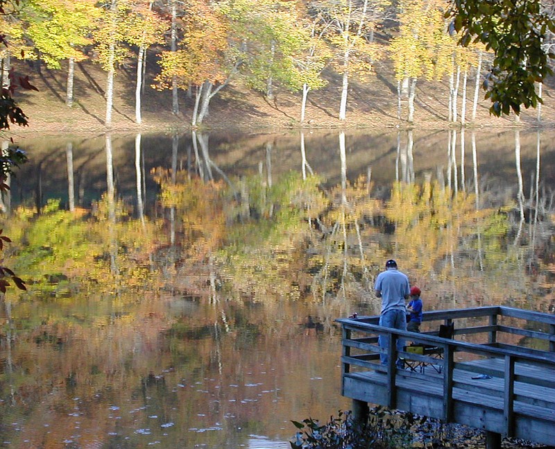 People enjoy fishing as fall colors reflect in the water at Cumberland Mountain State Park near Crossville, Tn. Sunday afternoon.