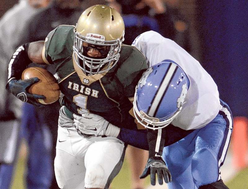 Notre Dame's Kareem Orr is brought down by McMinn Central's Zayne Baxter Friday at Finley Stadium.