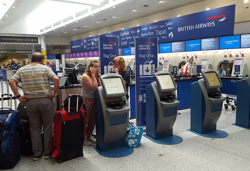 
              Passengers stand at a British Airways check-in desk after the airport suffered an IT systems failure, at London''s Gatwick Airport, Saturday, May 27, 2017. British Airways canceled all flights from London's Heathrow and Gatwick airports Saturday as a global IT failure caused severe disruption for travelers on a busy holiday weekend. (Gareth Fuller/PA via AP)
            