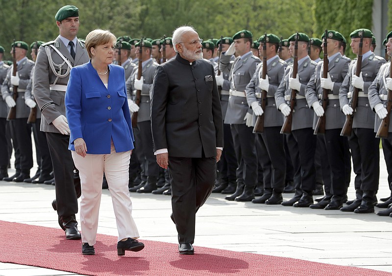 
              German Chancellor Angela Merkel, left, welcomes the Prime Minister of India, Narendra Modi, right, with military honors for a meeting at the chancellery in Berlin, Germany, Tuesday, May 30, 2017. (AP Photo/Michael Sohn)
            