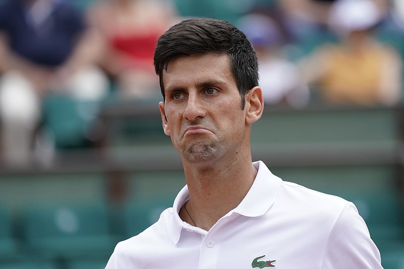 Serbia's Novak Djokovic grimaces as he plays Spain's Marcel Granollers during their first round match of the French Open tennis tournament at the Roland Garros stadium, Monday, May 29, 2017 in Paris. (AP Photo/Christophe Ena)