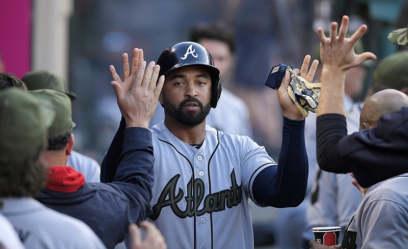 Atlanta Braves' Matt Kemp is congratulated by teammates after scoring on a ball hit by Tyler Flowers during the third inning of a baseball game against the Los Angeles Angels, Monday, May 29, 2017, in Anaheim, Calif. Angels second baseman Cliff Pennington was charged with an error while fielding the ball. (AP Photo/Mark J. Terrill)