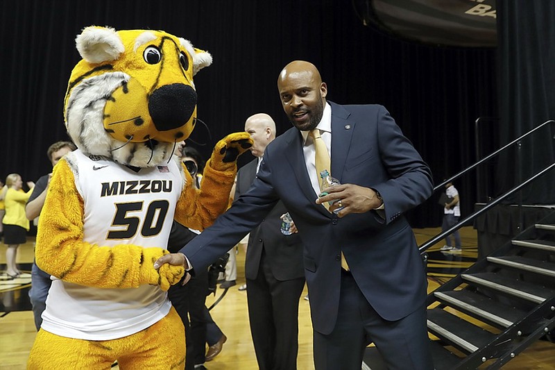 Cuonzo Martin shakes hands with the Missouri mascot, Truman the Tiger, after being introduced as the school's men's basketball coach in March. Martin coached at Tennessee from 2011 to 2014 and spent the past three seasons at California.