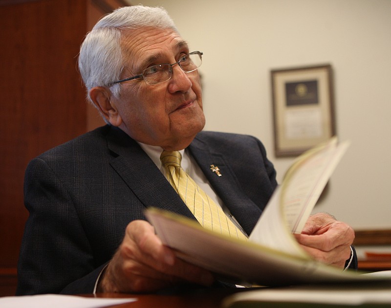 Hamilton County Clerk Bill Knowles talks with Times Free Press reporter Louie Brogdon, while flipping through marriage records from the 1970s, about record preservation at the County Courthouse on Monday.