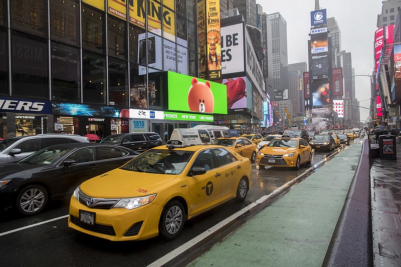 
              In this Thursday, May 25, 2017, photo, traffic makes it's way down Seventh Avenue in New York's Times Square. The attack that killed an 18-year-old woman and injured 20 other people in Times Square is spurring calls to ban cars from the famed "crossroads of the world." Eight years after Broadway became a pedestrian-only zone at Times Square, some city officials and others say the vehicle restrictions should be expanded to include Seventh Avenue. (AP Photo/Mary Altaffer)
            