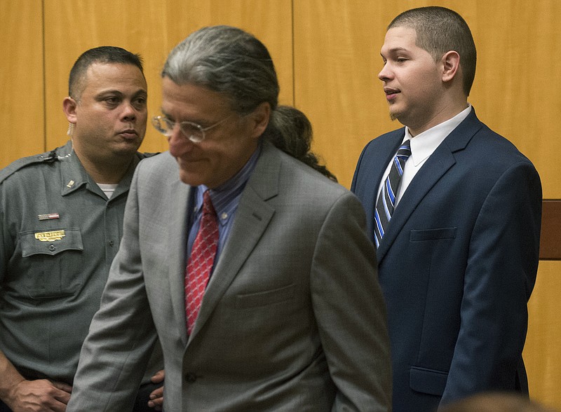 
              Tony Moreno, right, enters the courtroom in Middlesex Superior Court on Wednesday, May 31, 2017, for sentencing. Moreno was found guilty of murder and risk of injury to a child in February. He threw his 7-month-old son Aaden to his death from the Arrigoni Bridge on July 5, 2015. He then jumped off, but survived. (Patrick Raycraft/Hartford Courant via AP, Pool)
            