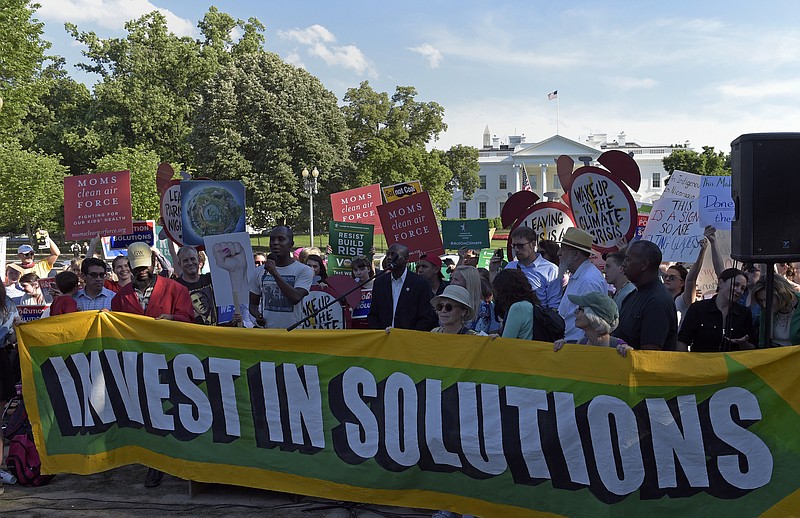 Demonstrators gather outside the White House in Washington, Thursday to protest President Donald Trump's decision to withdraw the United States from the Paris climate change accord. (AP Photo/Susan Walsh)