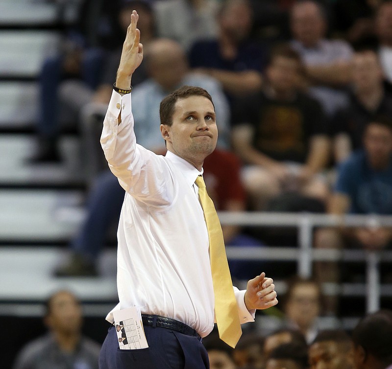 FILE - In this March 16, 2017, file photo, VCU coach Will Wade gestures as he looks at the scoreboard during the first half against Saint Mary's in the first round of the NCAA men's college basketball tournament in Salt Lake City. Wade is leaving VCU to take over LSU after guiding the Rams to the NCAA Tournament in both his seasons as coach. Vice chancellor and athletic director Joe Alleva made the announcement Monday night, March 20, 2017, on LSU’s athletics website and Twitter.(AP Photo/George Frey, File)