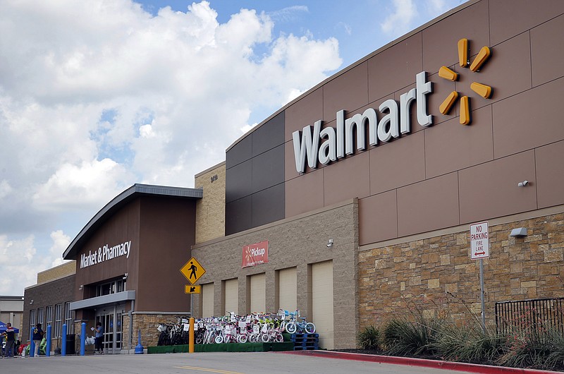
              FILE - In an  Aug. 26, 2016 file photo, people walk in and out of a Walmart store, in Dallas. Walmart is testing a delivery service using its own store employees, who will deliver packages ordered online while driving home from their regular work shifts. The world's largest retailer says workers can choose to participate and would be paid. The service is being tested at two stores in New Jersey and one in Arkansas.  (AP Photo/Tony Gutierrez, File)
            