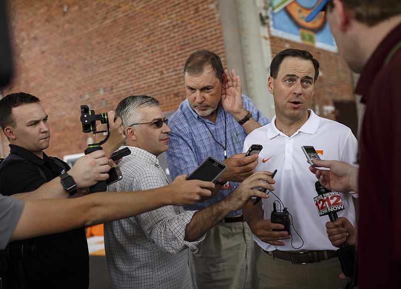 Tennessee athletic director John Currie, right, speaks to media at the Big Orange Caravan's stop at the First Tennessee Pavilion on Saturday, June 3, 2017, in Chattanooga, Tenn. The event gave fans the chance to meet Tennessee Athletics coaches and new athletic director John Currie.