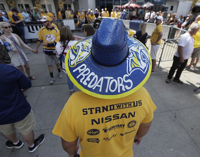 
              A Nashville Predators fan walks outside the arena before Game 3 of the NHL hockey Stanley Cup Finals between the Nashville Predators and the Pittsburgh Penguins Saturday, June 3, 2017, in Nashville, Tenn. (AP Photo/Mark Humphrey)
            
