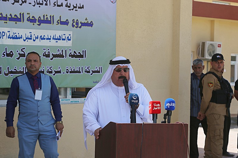 
              In this Thursday, June 1, 2017 photo, Sheikh Talib Al-Hasnawi, center, the head of the municipal council speaks during the opening ceremony of a water station in Fallujah, Iraq. Iraqi officials say billions of dollars and years of work are needed to rebuild Fallujah, but as Iraq struggles through an economic crisis, they concede they don't know where the funds will come from. (AP Photo/Khalid Mohammed)
            