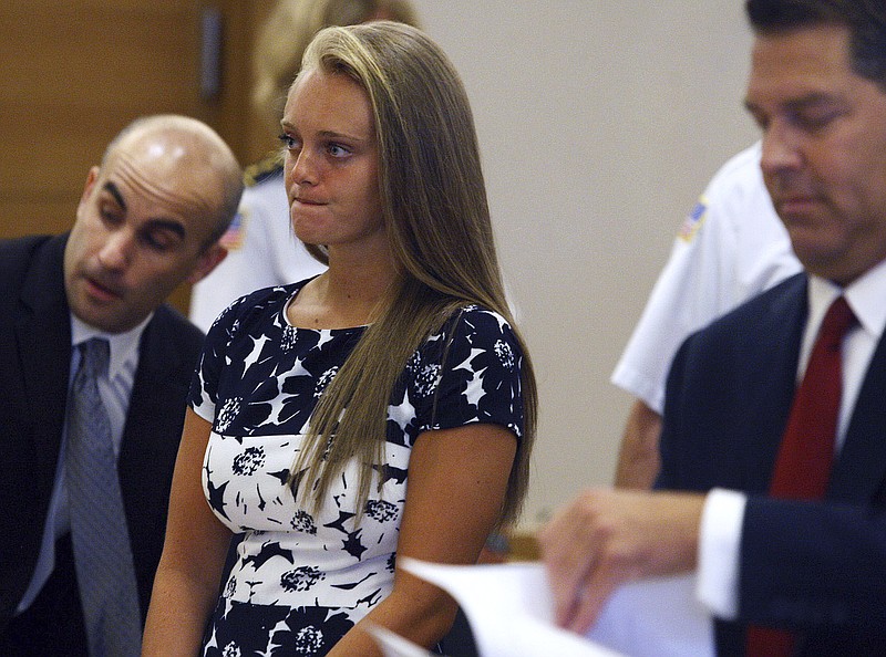 
              FILE-- In this July 29, 2016, file photo Michelle Carter stands with her attorneys at the Bristol County Juvenile Court in Taunton, Mass. Jury selection is set to begin Monday, June 5, 2017, in the trial of Carter who is accused of sending her boyfriend dozens of text messages encouraging him to kill himself. (George Rizer/The Globe via AP, Pool, File)
            