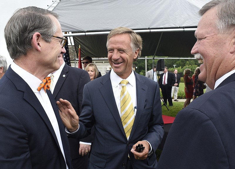 Gov. Bill Haslam, center, talks with Tennessee State Senator Bo Watson, left, and Hamilton County Mayor Jim Coppinger.  Tennessee Gov. Bill Halsam  signed the IMPROVE Act Bill at the Tennessee Welcome Center in East Ridge, Tenn. on June 4, 2017.