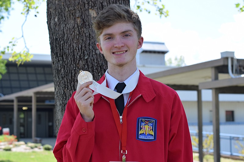 Michael York holds up his first place medal after winning the welding competition at the Tennessee SKILLS Competition. (Contributed photo)